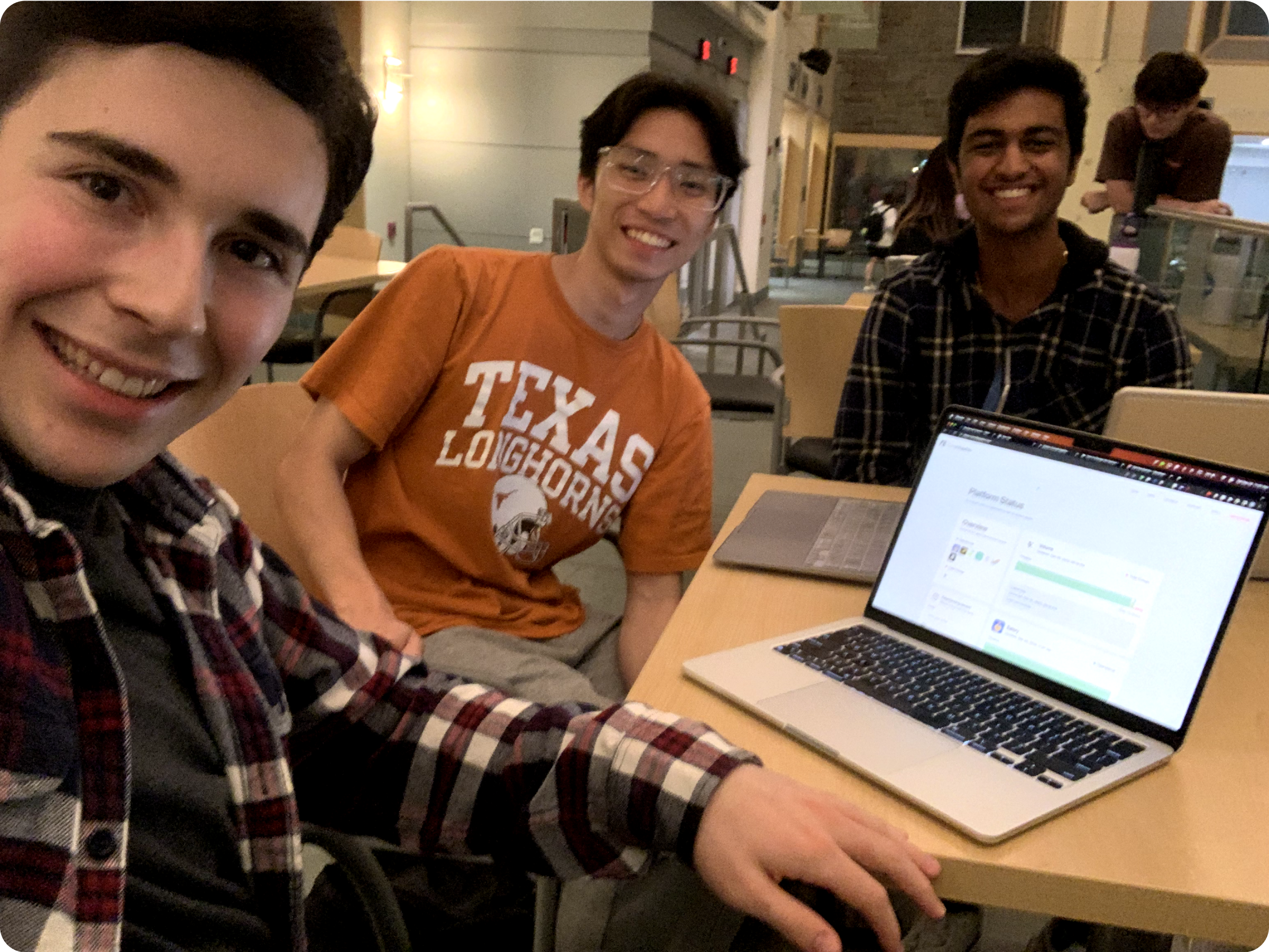 Me (middle), Zach Seidner (left), and Archit Mehta (right) in the last hour of our 13-hour hack.